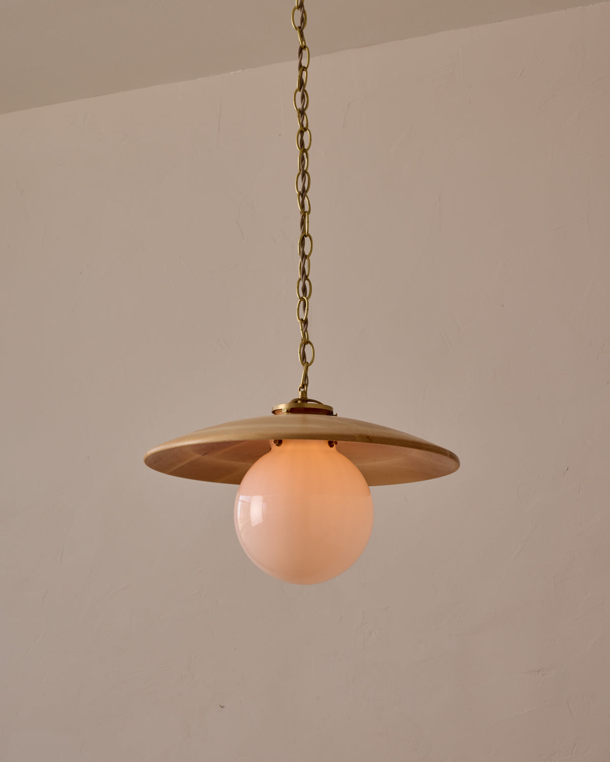 Large pendant light with oversized clear glass globe and decorative wooden clear maple shade with brass chain #shade-finish_natural maple #globe_white glass #cord-color_beige
