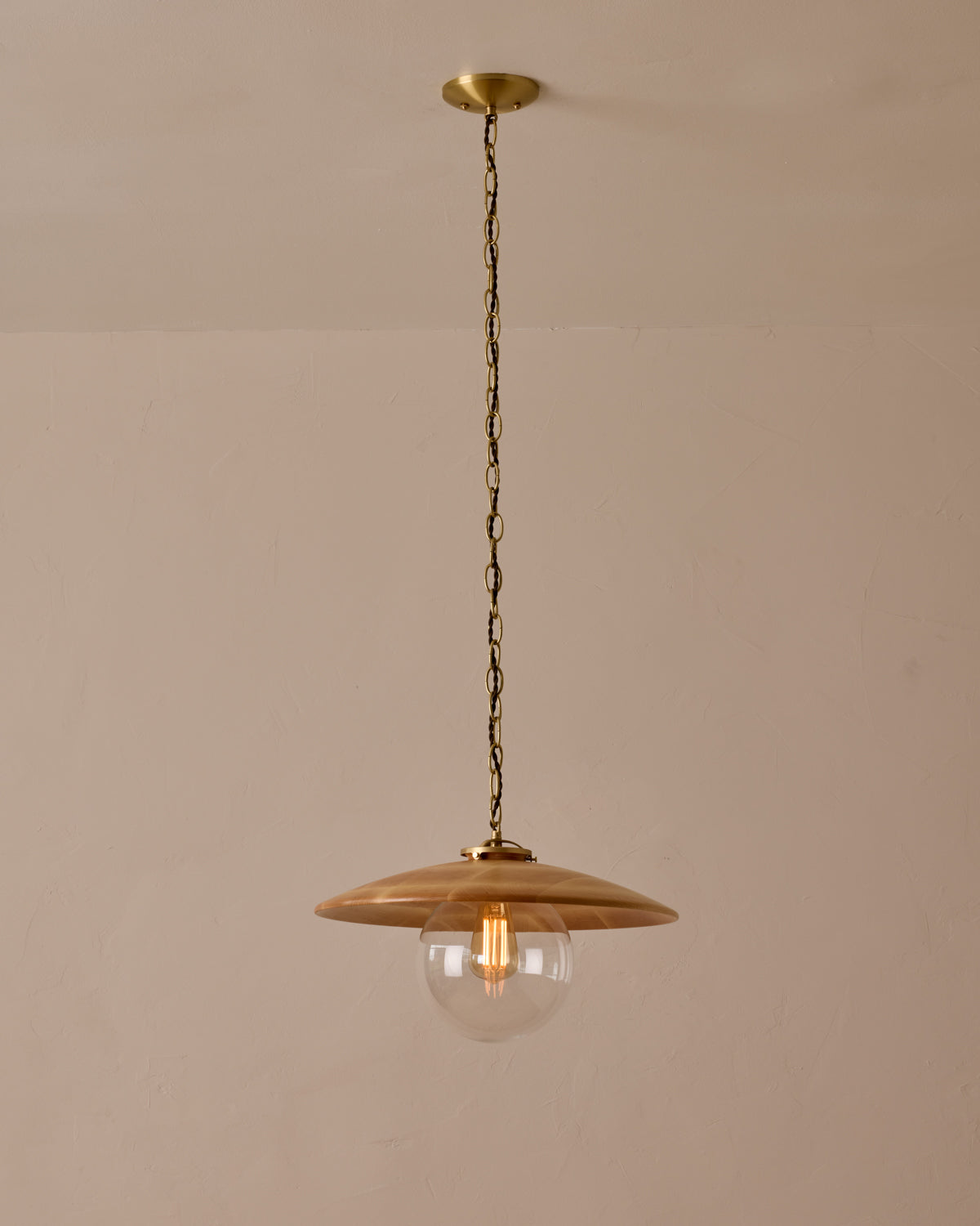 Large pendant light with oversized clear glass globe and decorative wooden clear maple shade with brass chain #shade-finish_natural maple #globe_clear glass #cord-color_brown