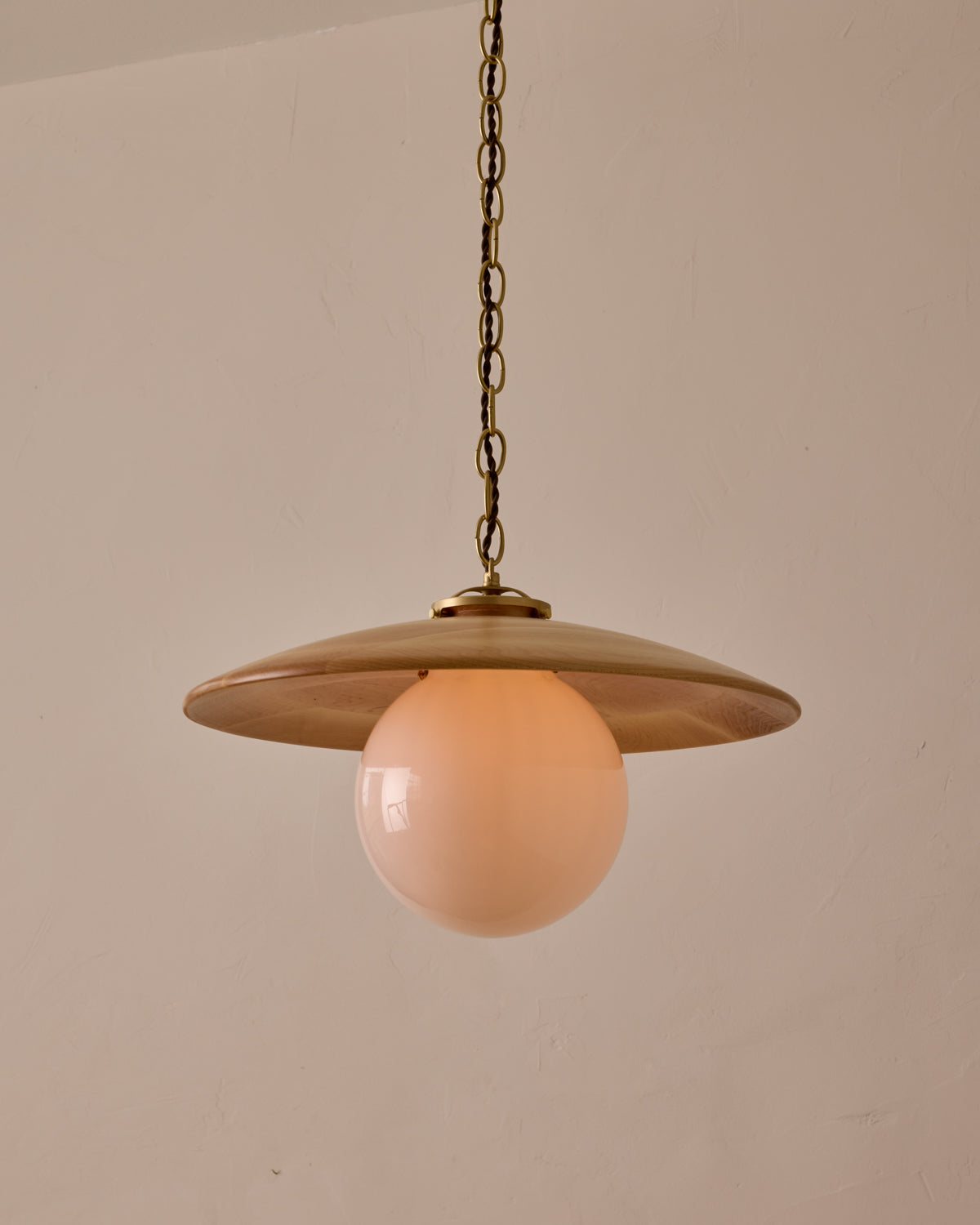 Large pendant light with oversized clear glass globe and decorative wooden clear maple shade with brass chain #shade-finish_natural maple #globe_white glass #cord-color_brown