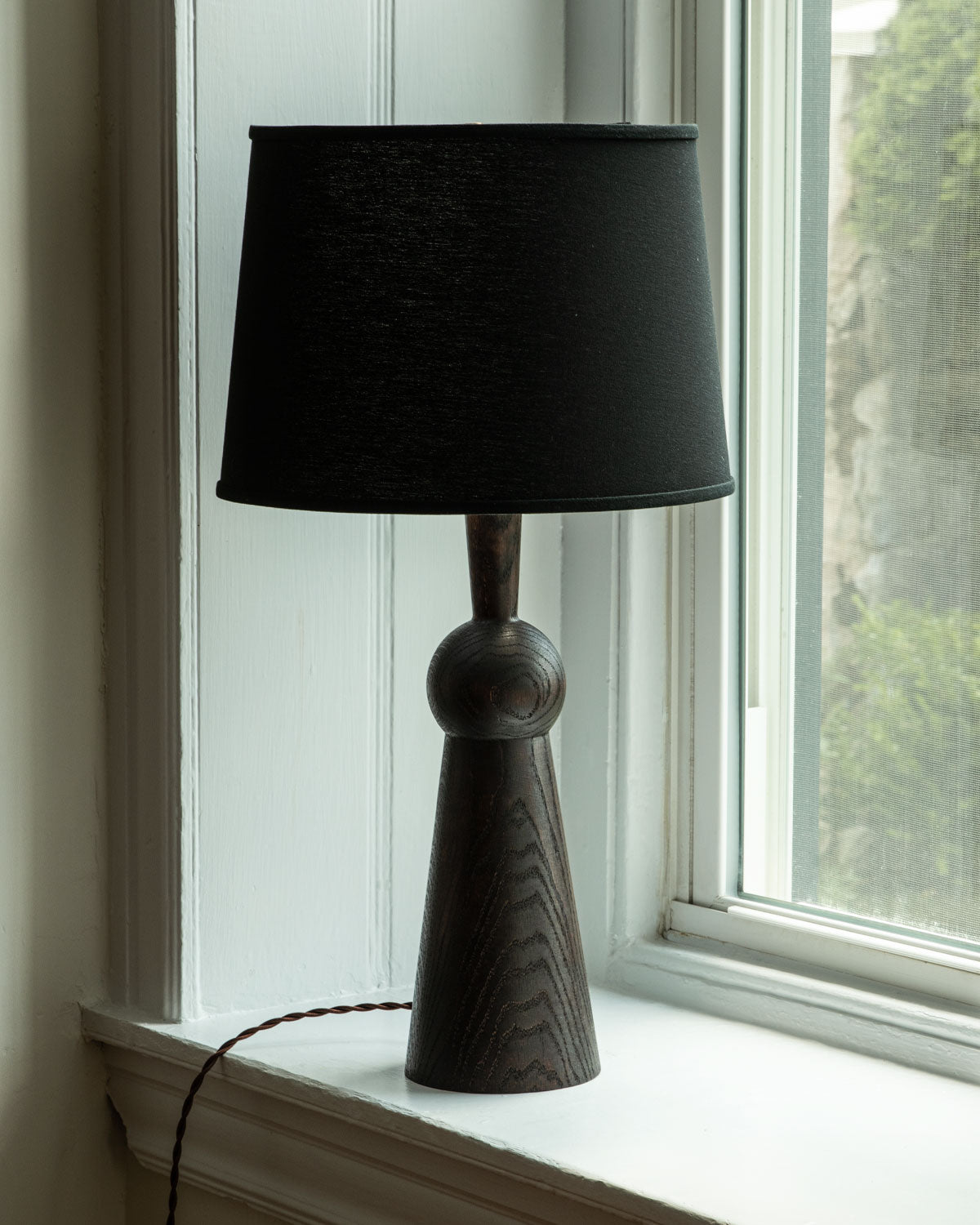 Dark wash solid wood table lamp with gently tapered body and black linen shade #wood-finish_dark wash red oak #shade-color_black linen
