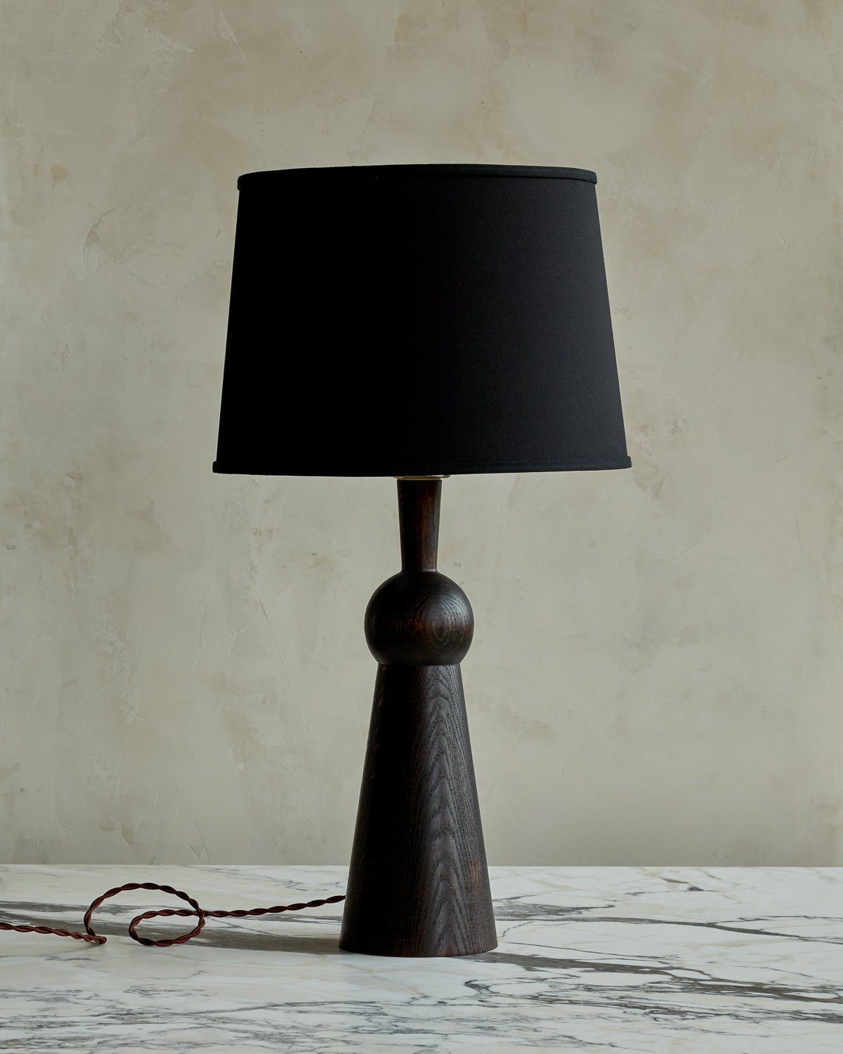 Dark wash solid wood table lamp with gently tapered body and black linen shade #wood-finish_dark wash red oak #shade-color_black linen