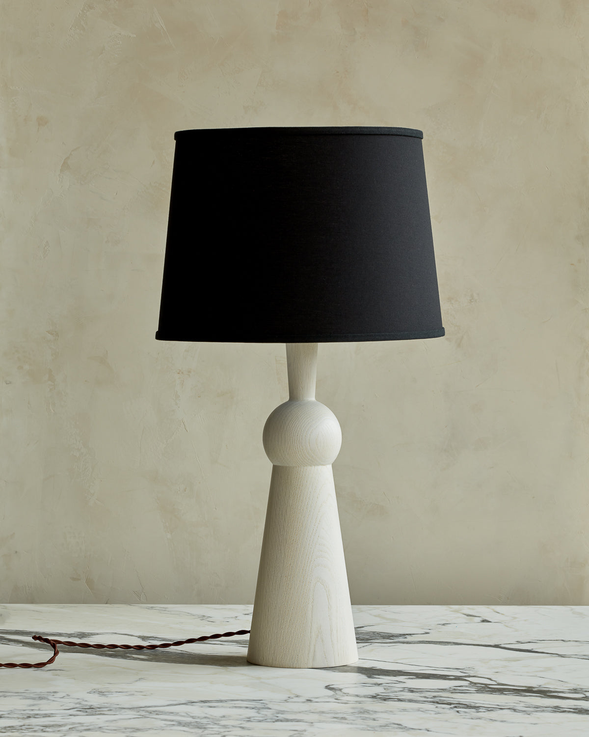 White wash solid wood table lamp with gently tapered body and black linen shade #wood-finish_white wash red oak #shade-color_black linen