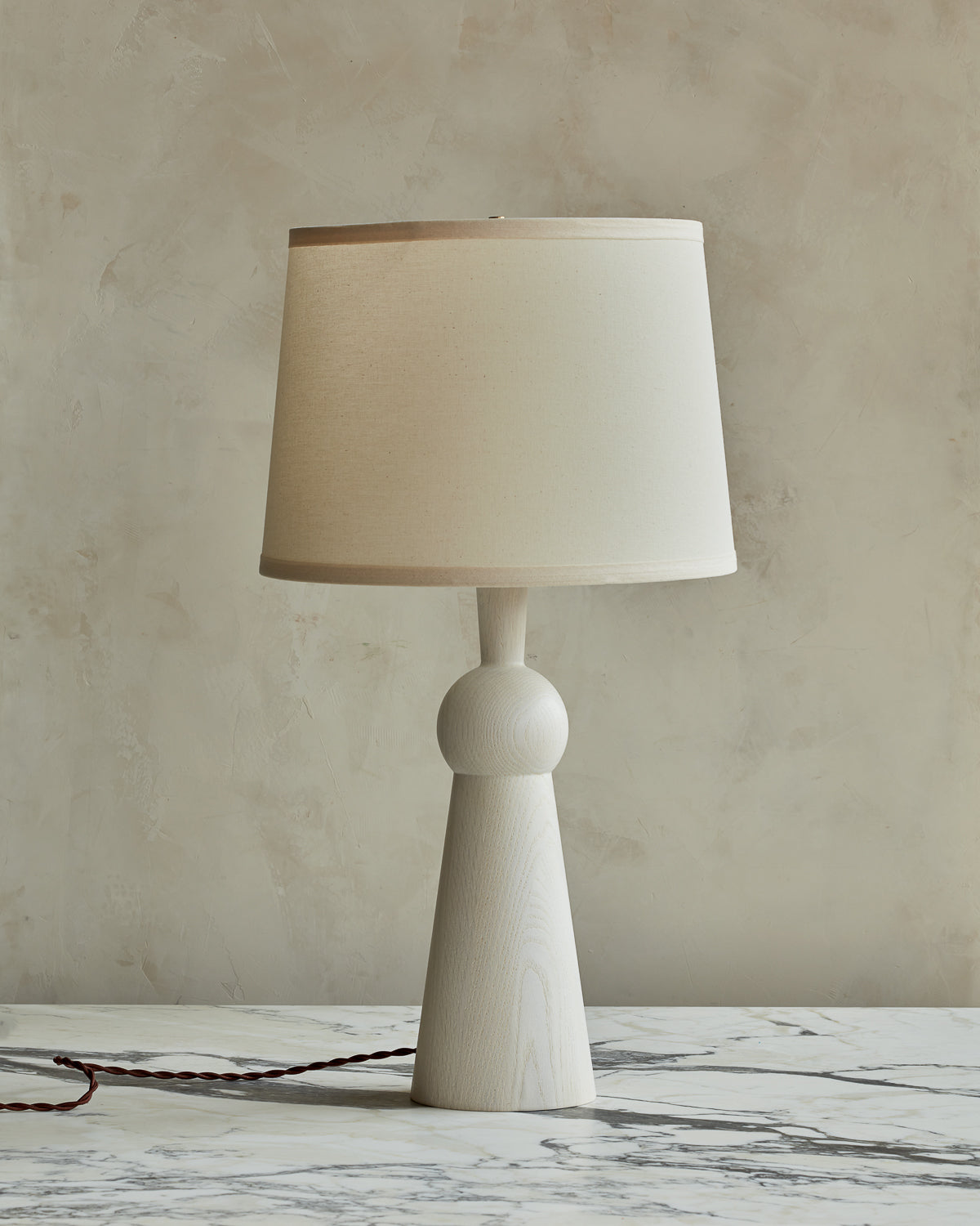 White wash solid wood table lamp with gently tapered body and ivory linen shade #wood-finish_white wash red oak #shade-color_ivory linen