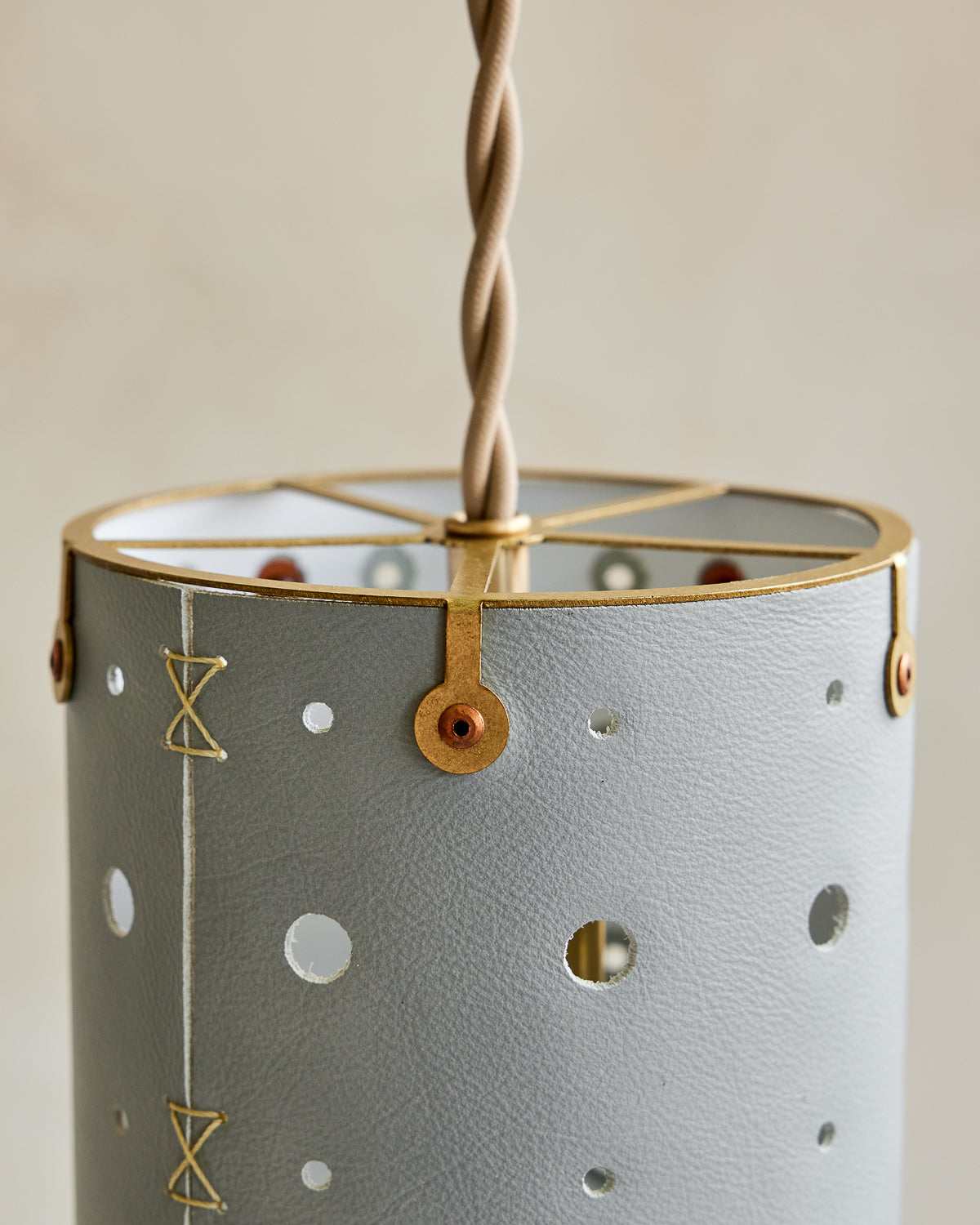 Charming leather pendant light with blue handstitched shade and brass accents #color_cloud blue