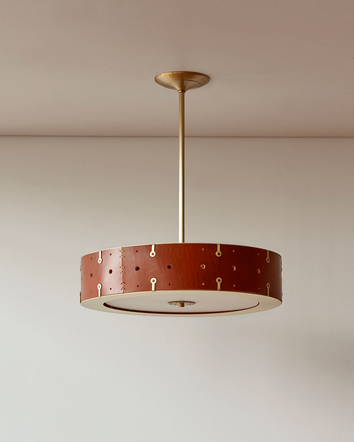 Beautiful satin brass ceiling pendant fixture with handstitched leather drum shade and customizable drop
#leather-color_tan harness #size_18" drum