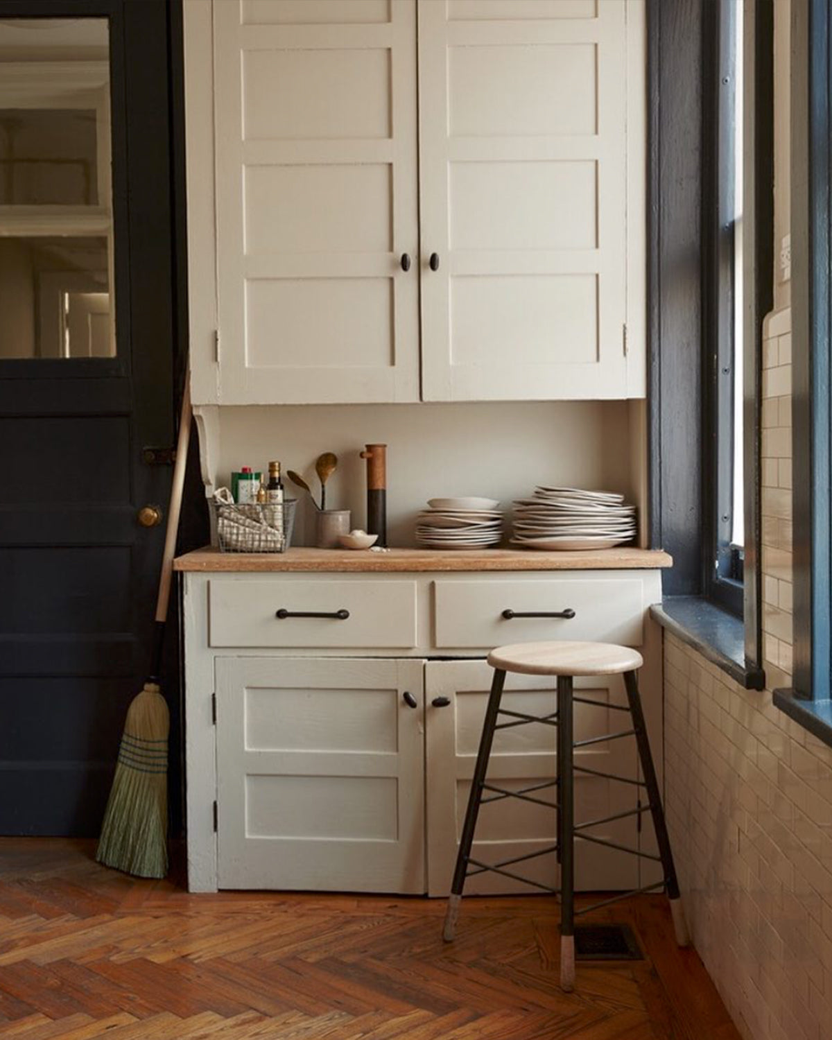LOSTINE WHITEWASH GORDON STOOL - IRON BASE in kitchen utility corner, household essentials- Classic ladder metal base stool with wooden seat and feet, workshop stool. Counter and bar height. Made by Lostine in Philadelphia. Simple interior design, made in the USA. Warm American Modern Design