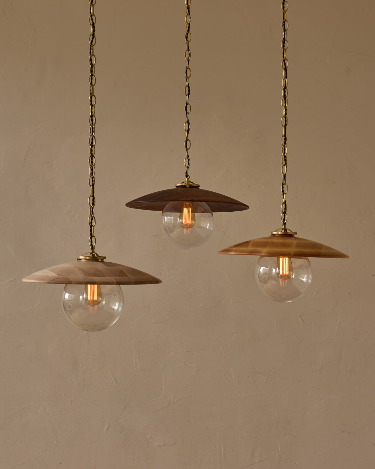 Large pendant light with oversized clear glass globe and decorative wooden clear maple shade with brass chain  #shade-finish_natural maple #globe_clear glass #cord-color_brown