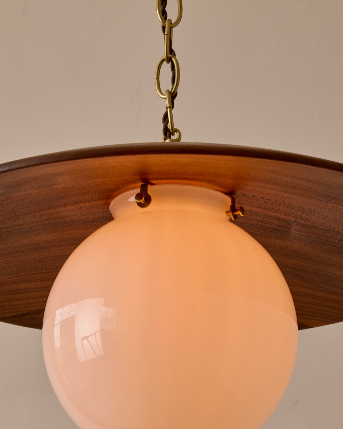 Large pendant light with oversized clear glass globe and decorative wooden clear maple shade with brass chain  #shade-finish_black walnut #globe_white glass #cord-color_brown
