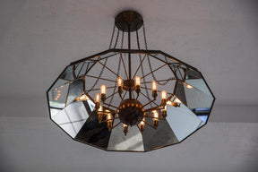 Victorian style metal chandelier with mirrored interior and edison bulbs
