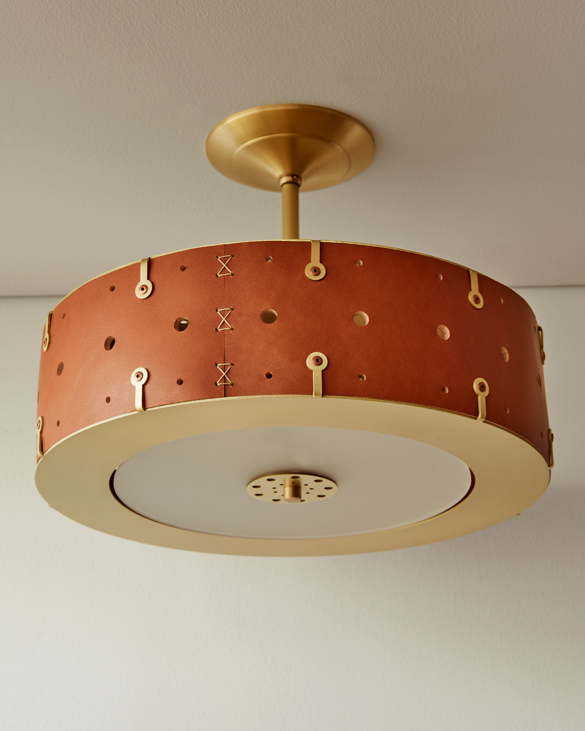 Beautiful satin brass ceiling pendant fixture with handstitched leather drum shade and customizable drop
#leather-color_tan harness #size_14" drum